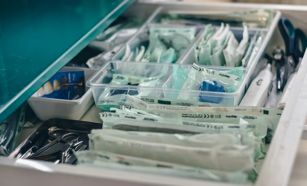 Organized drawer of sterile medical supplies in a clinical treatment room